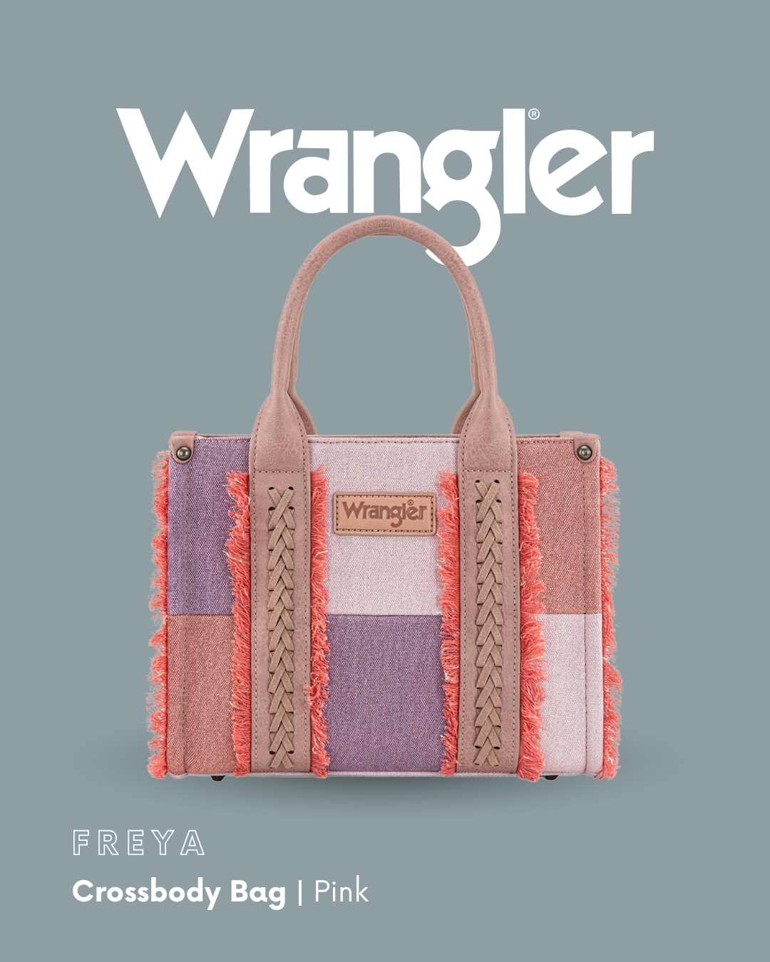 Wrangler Freya Crossbody Bag in pink, featuring a patchwork design with dusty pink, lavender, and coral fringed details, set against a solid slate blue background with the Wrangler logo.