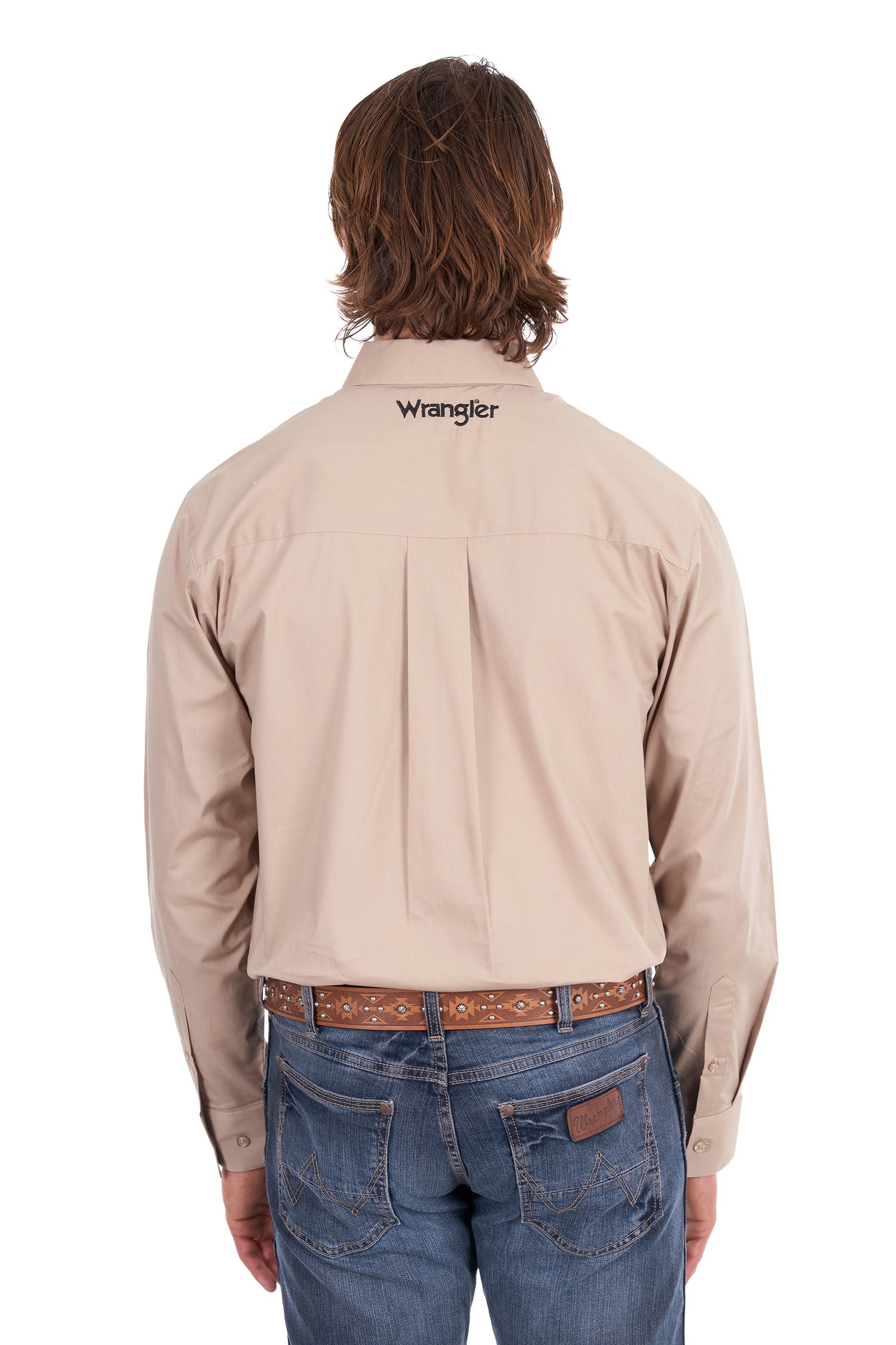 A man viewed from behind wearing a light beige Wrangler long-sleeve button-down shirt tucked into blue jeans with a brown patterned belt, against a plain white background.