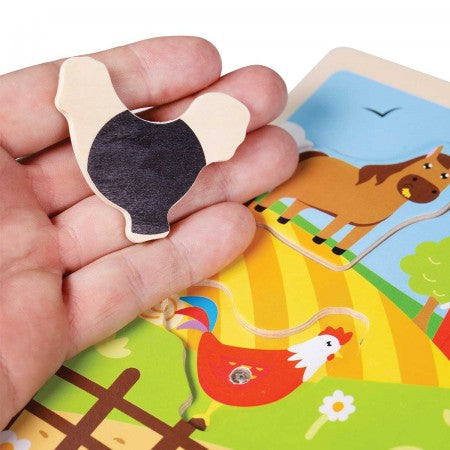Bigjigs Farm Sound Puzzle. Hand holding a wooden puzzle piece with a horse illustration on a farm-themed puzzle.