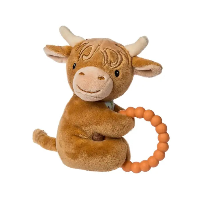 Plush highland cow toy with a teething ring on a white background