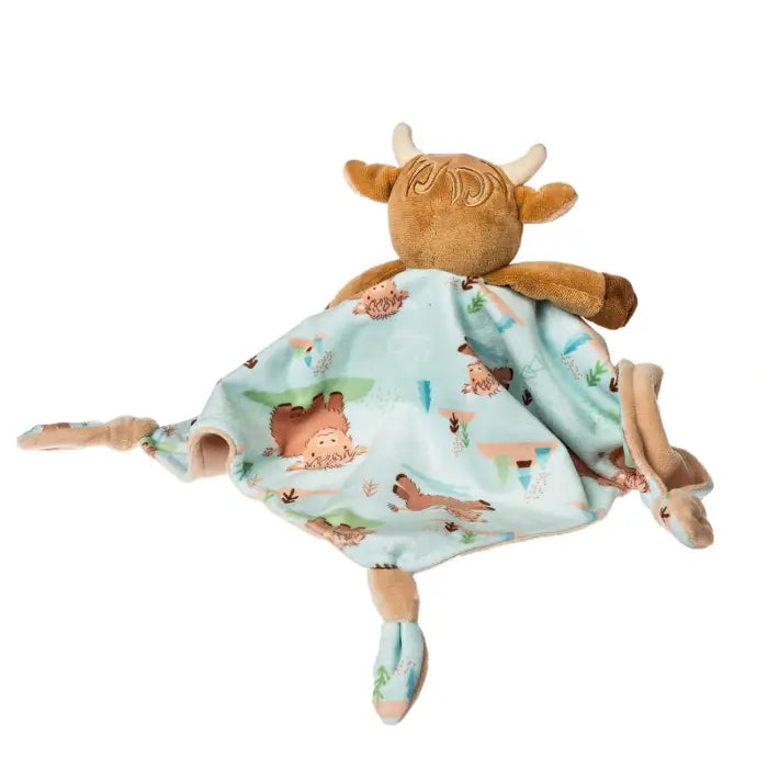 Plush toy cow with a blanket featuring animal prints on a white background
