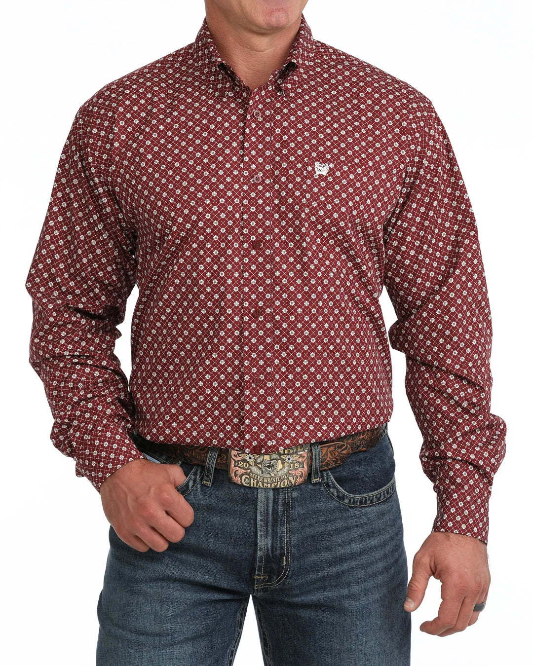 Man wearing a patterned red shirt and jeans on a white background