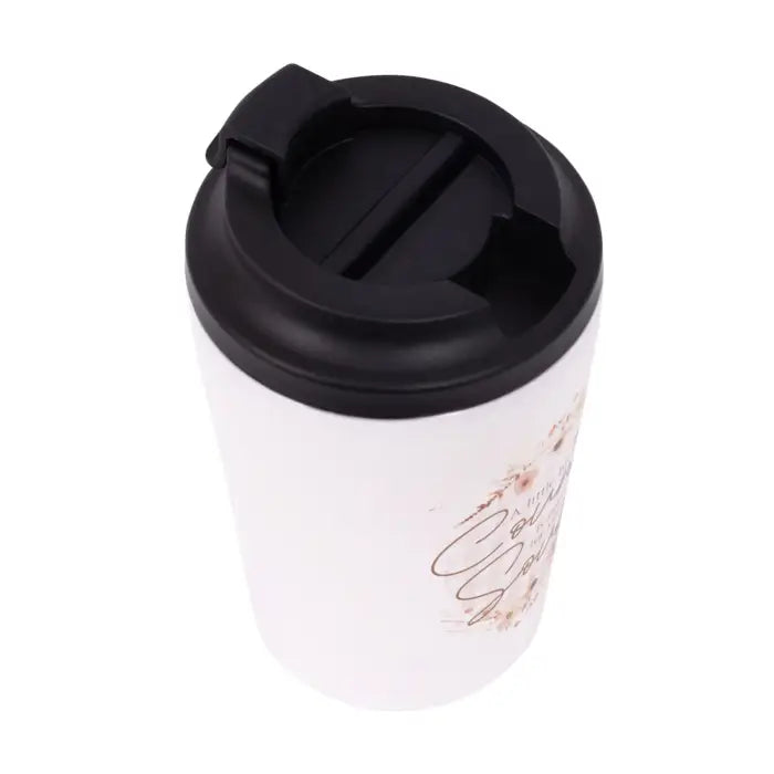 A white travel tumbler with a black flip-top lid, featuring a subtle rose gold cursive script and floral print on the side.