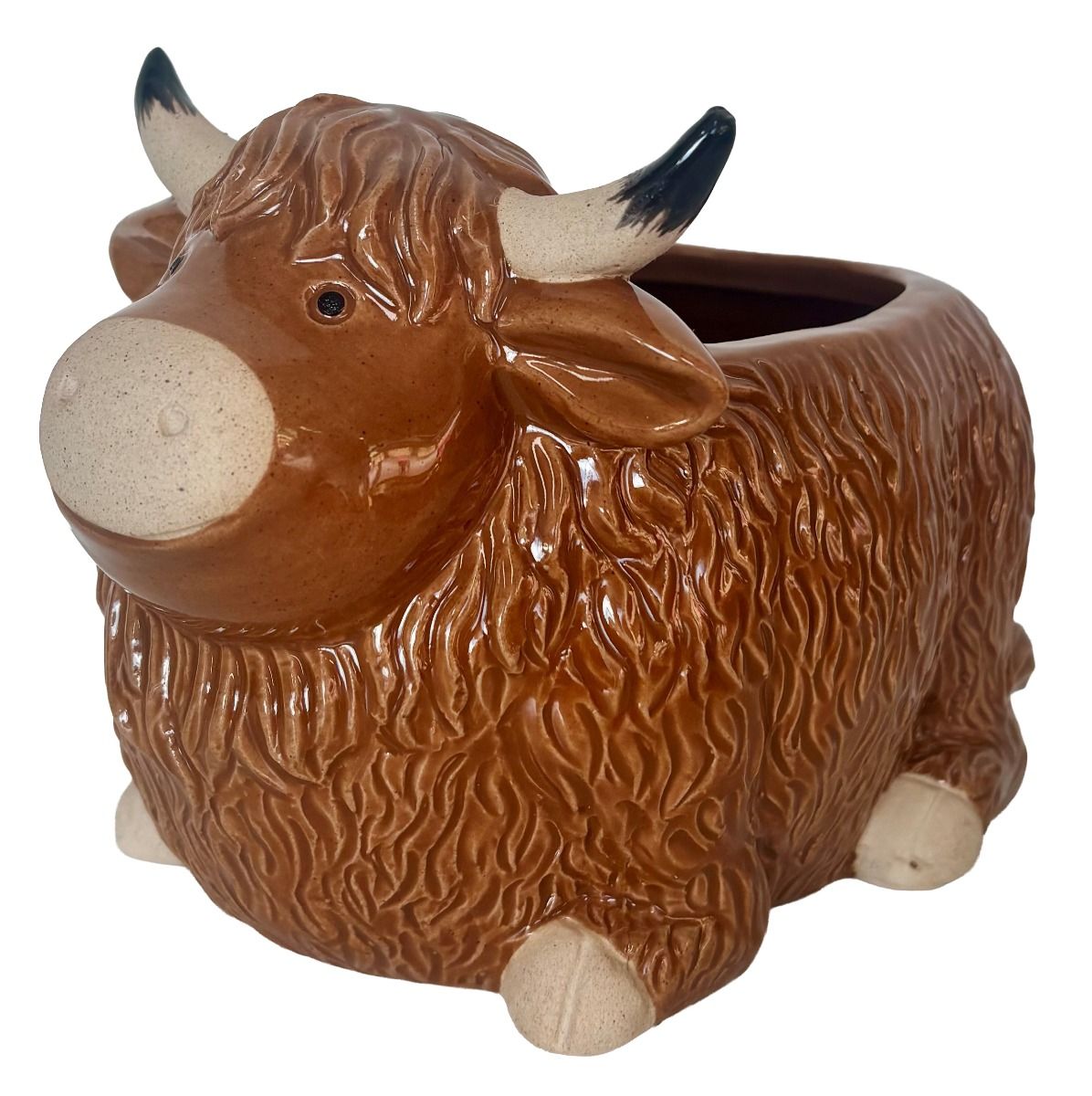 A ceramic planter shaped like a Highland cow, featuring a glossy brown textured body with cream-colored hooves, nose, and horns with black tips, set against a plain white background.