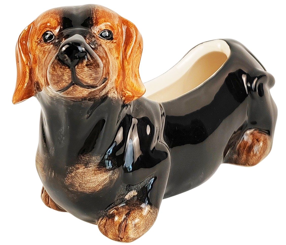 Ceramic dog-shaped container with a realistic design on a white background
