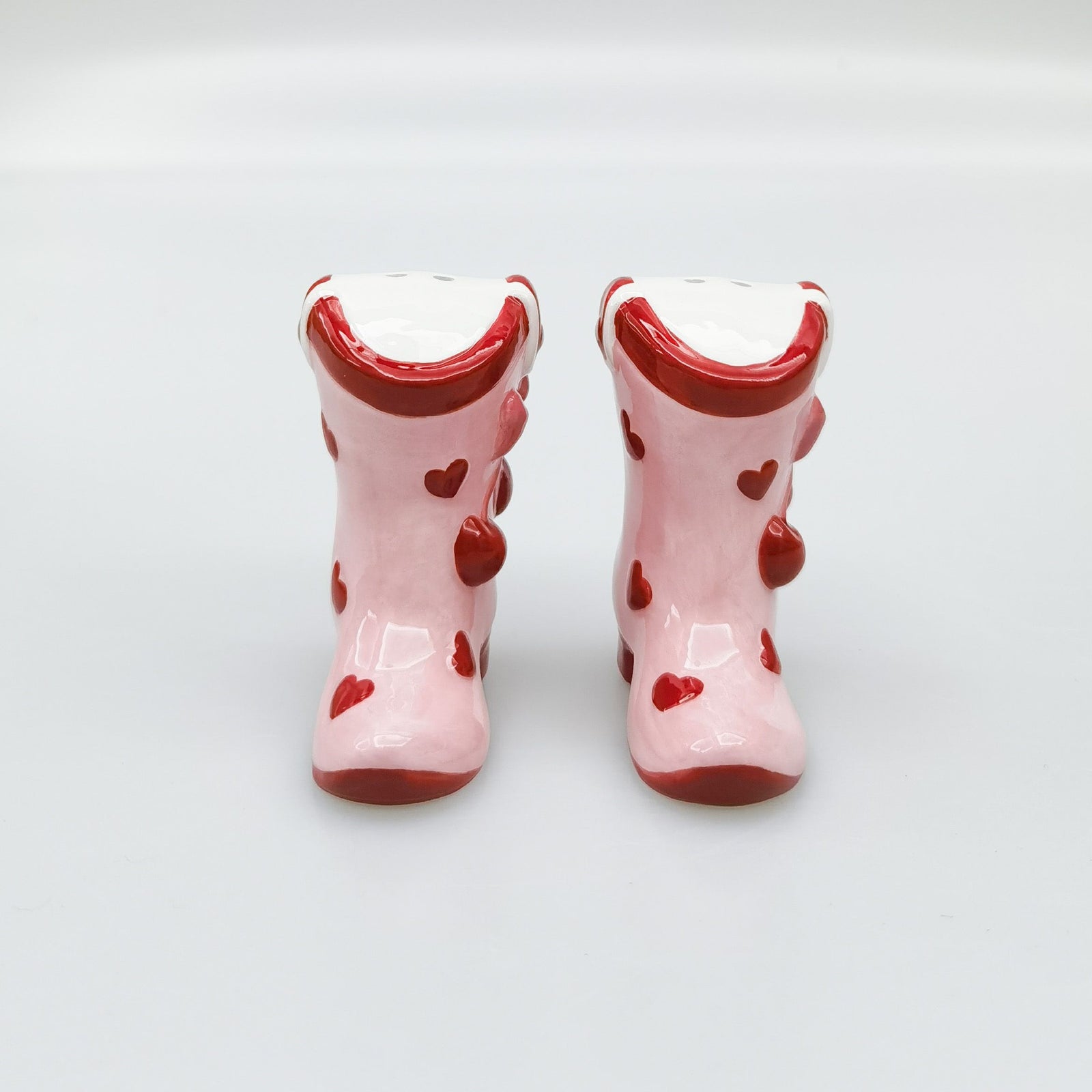Urban Products 7cm Cherry Boot Salt & Pepper Shaker. Pink rubber boots with red heart patterns on a light gray background
