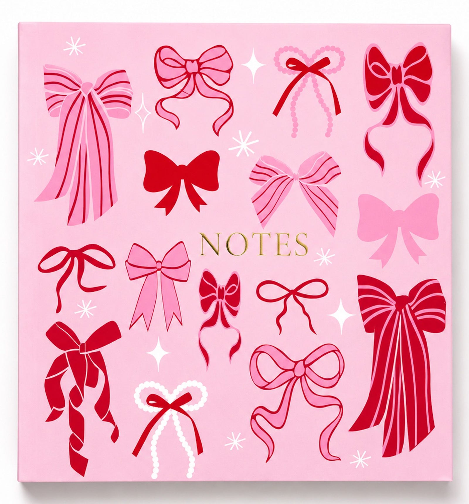 A pink square notebook cover decorated with various red and pink ribbon illustrations, white starbursts, and the word 'NOTES' in gold lettering in the center.