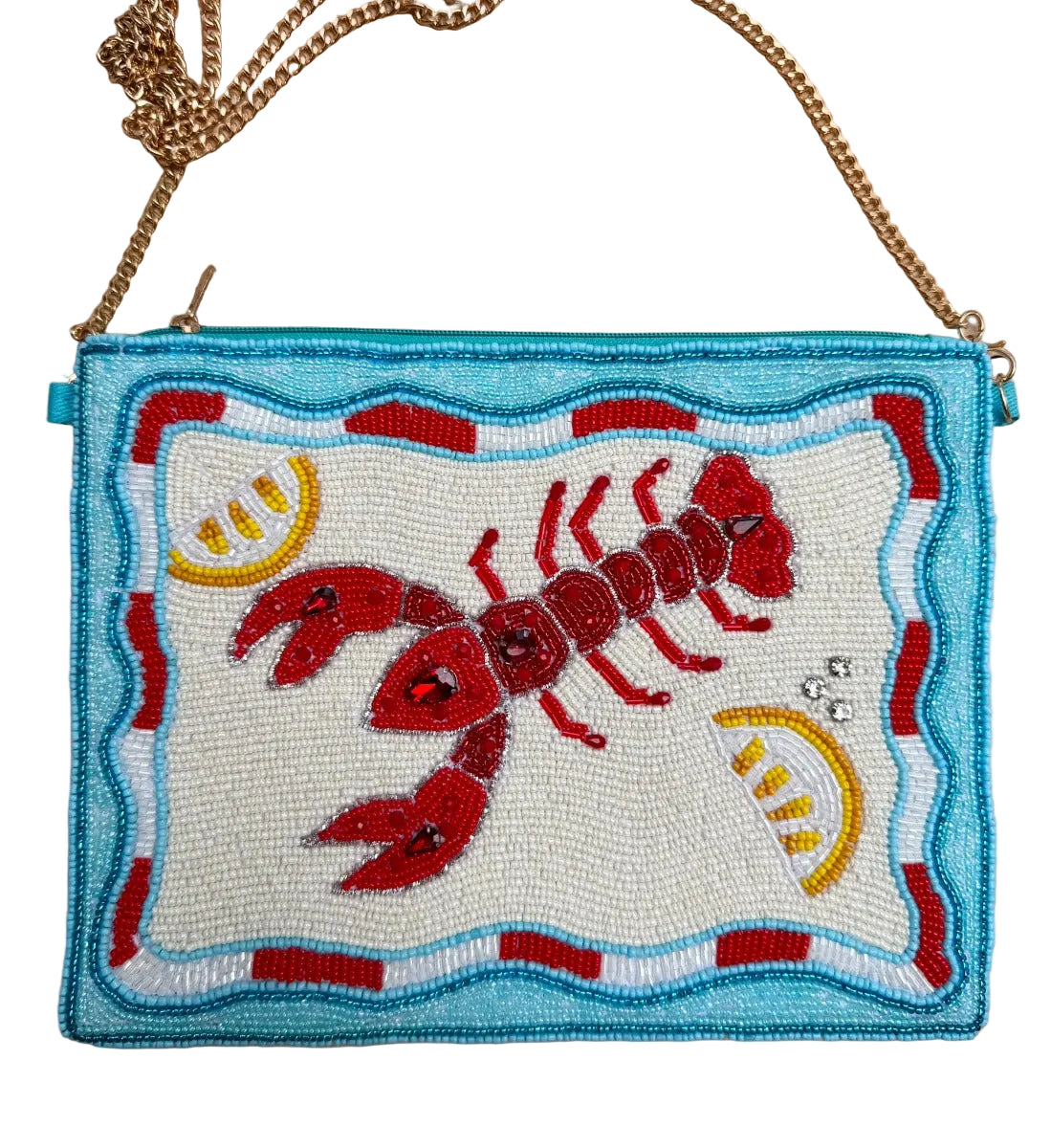 Handbag with beaded design of a red lobster on a beige surface