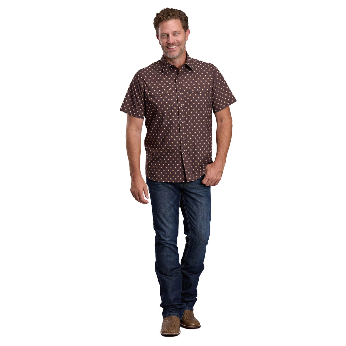 Man wearing a patterned shirt and jeans on a white background
