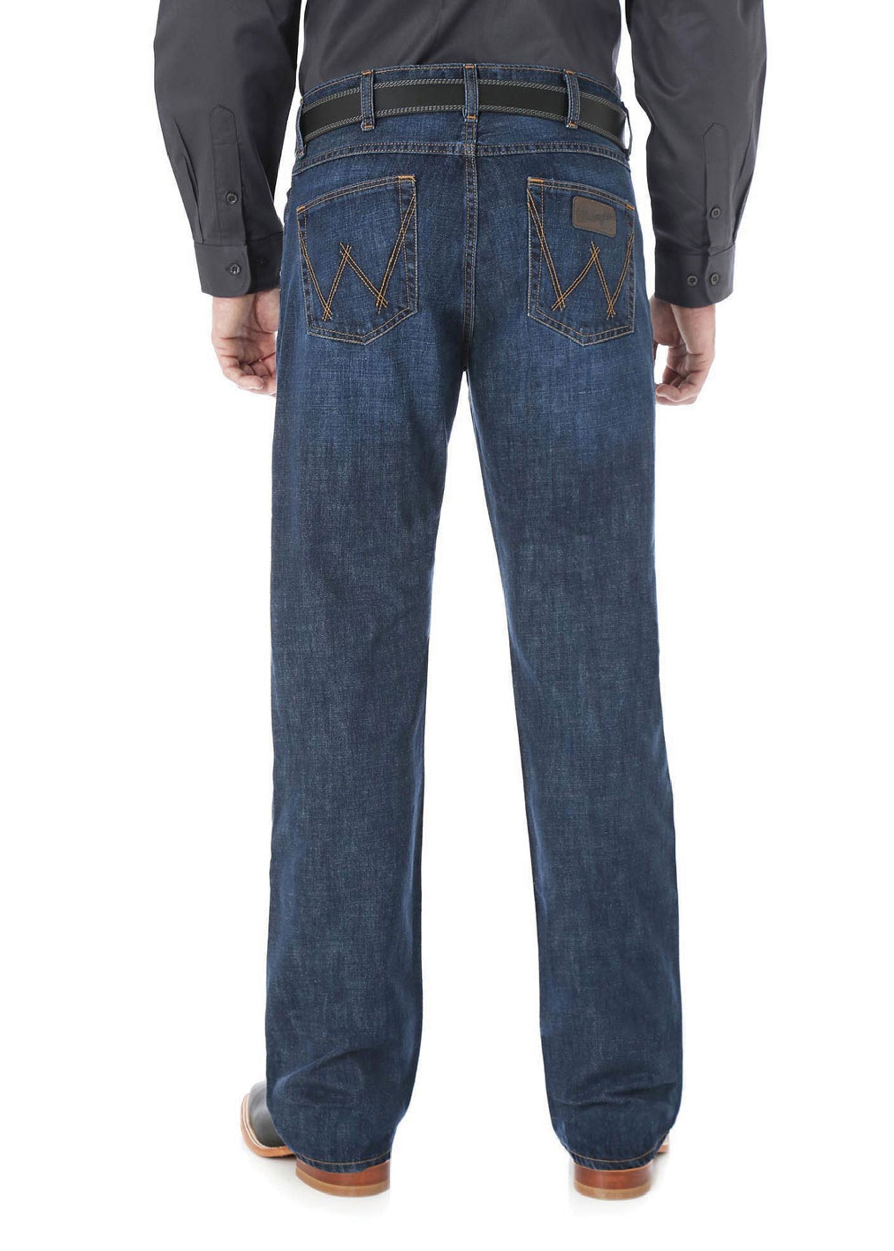 Wrangler Men's 20X Competition Slim Bootcut Jean. Person wearing blue jeans with a brown belt and shoes on a white background