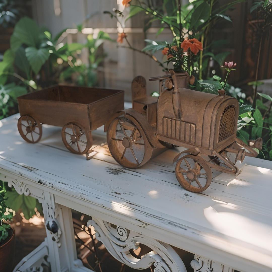 Rustic metal tractor and cart garden decor displayed on a distressed white wooden table in an outdoor garden setting.