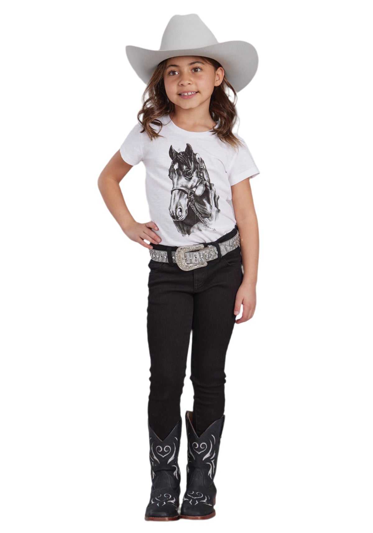 Roper Girl's Horse Print Five Star Tee. Young girl in cowboy hat and boots wearing a horse-themed t-shirt and black pants.
