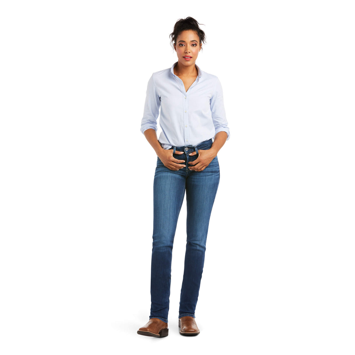 Ariat Women's Abby Perfect Rise Straight Leg Jean. Woman wearing a light blue shirt and dark blue jeans on a white background