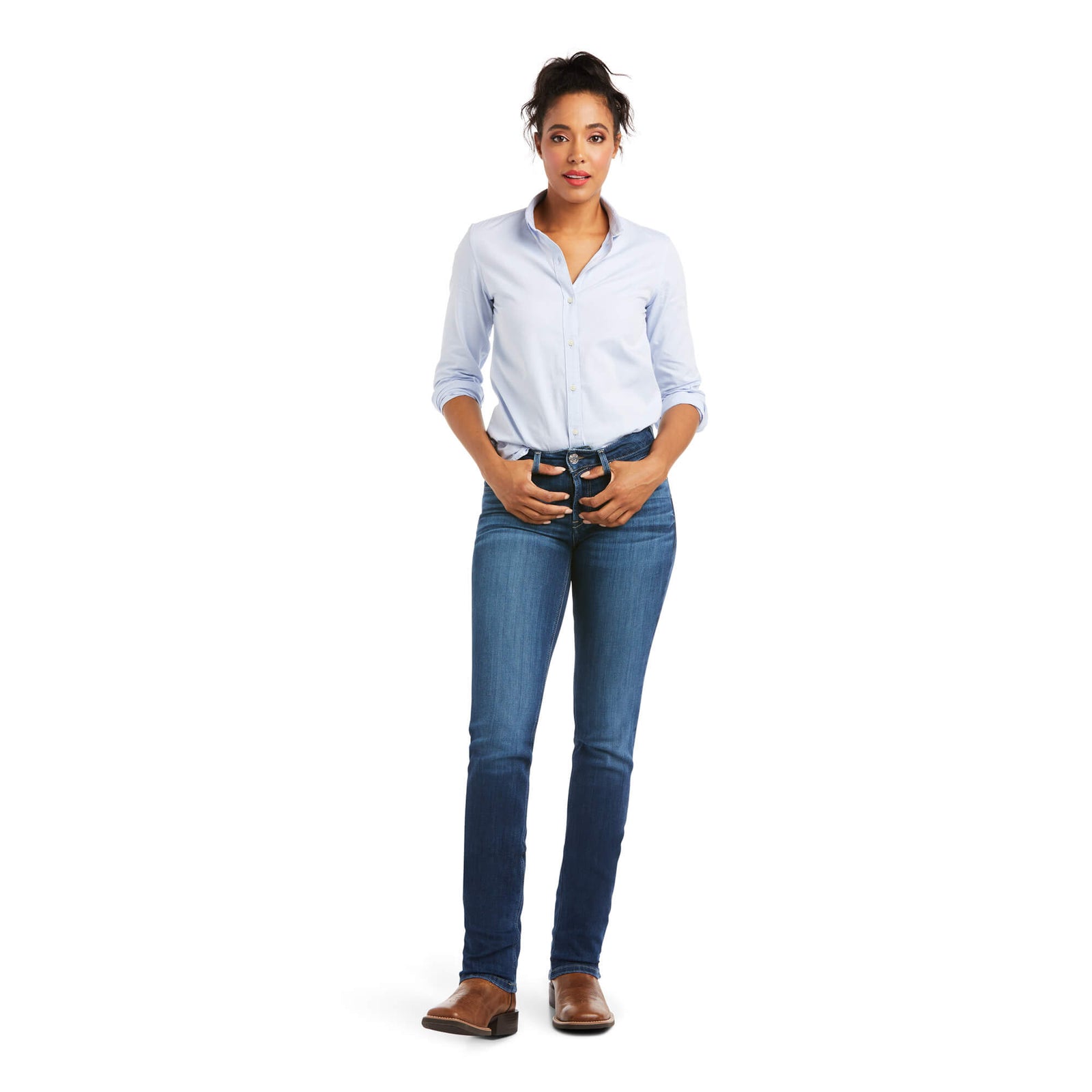 Ariat Women's Abby Perfect Rise Straight Leg Jean. Woman wearing a light blue shirt and dark blue jeans on a white background