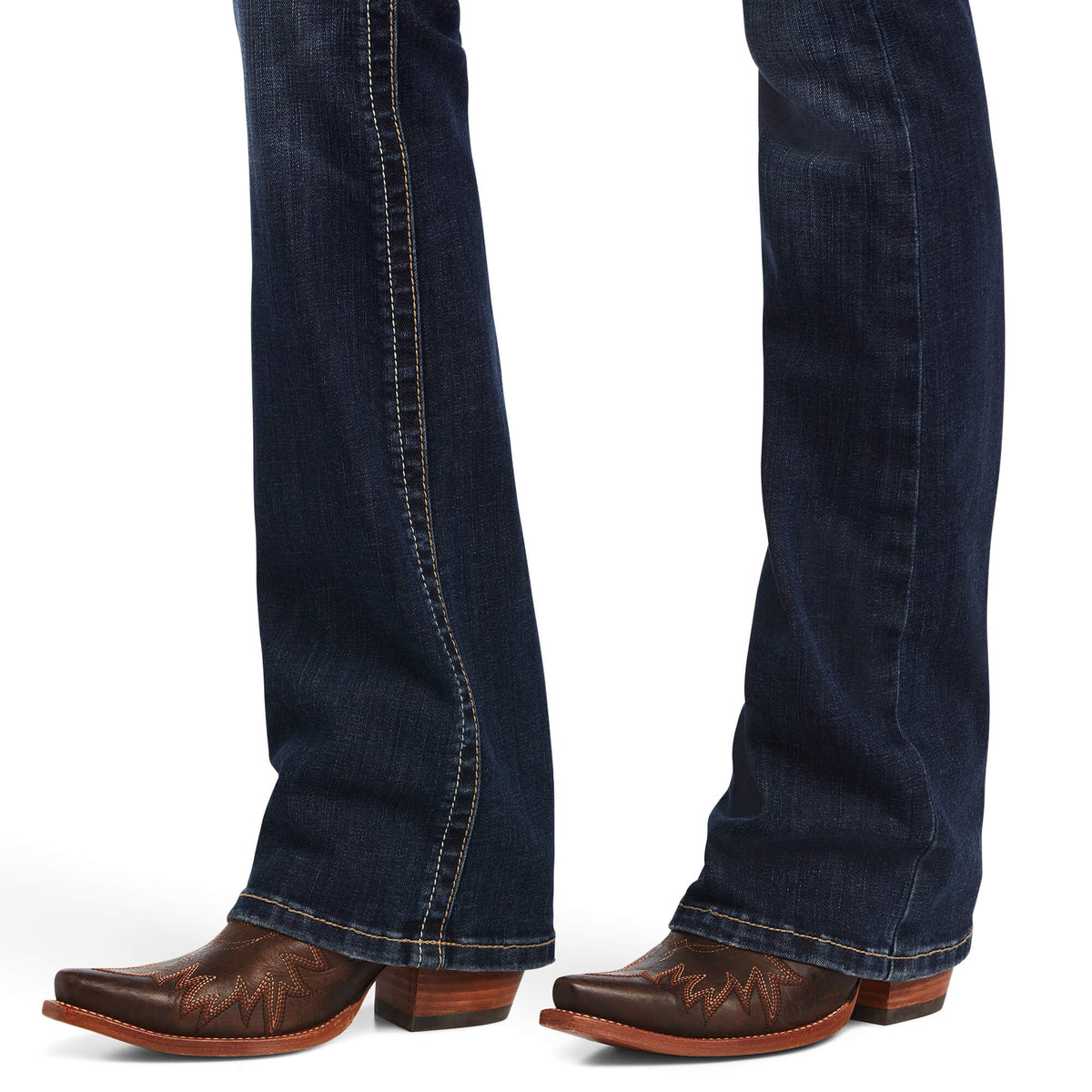 Ariat Women's Lexie Perfect Rise Boot Cut Jean. Blue jeans worn with brown boots on a white background