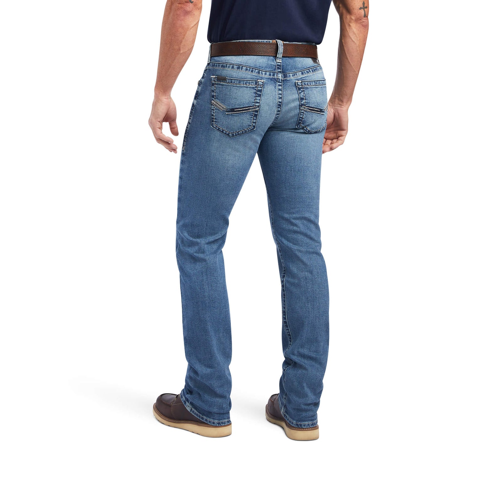 A man standing straight, wearing Ariat Men's M7 Wessley Straight Leg Jean with a belt and brown shoes.