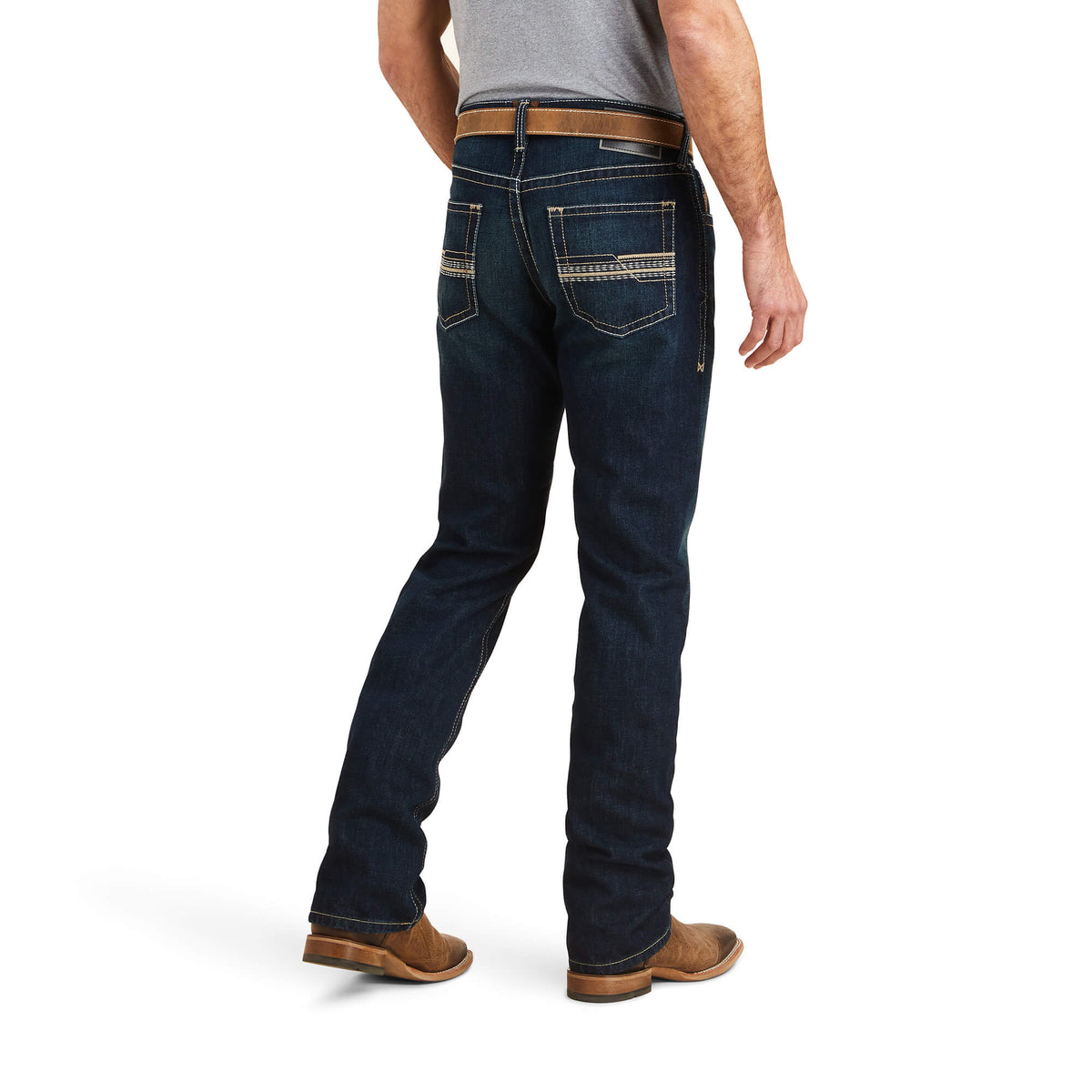 Ariat Men's M5 Winifield Straight Leg Jean. A man wearing Ariat Men's M5 Winifield Straight Leg Jean in a dark wash, paired with a gray shirt and brown shoes.