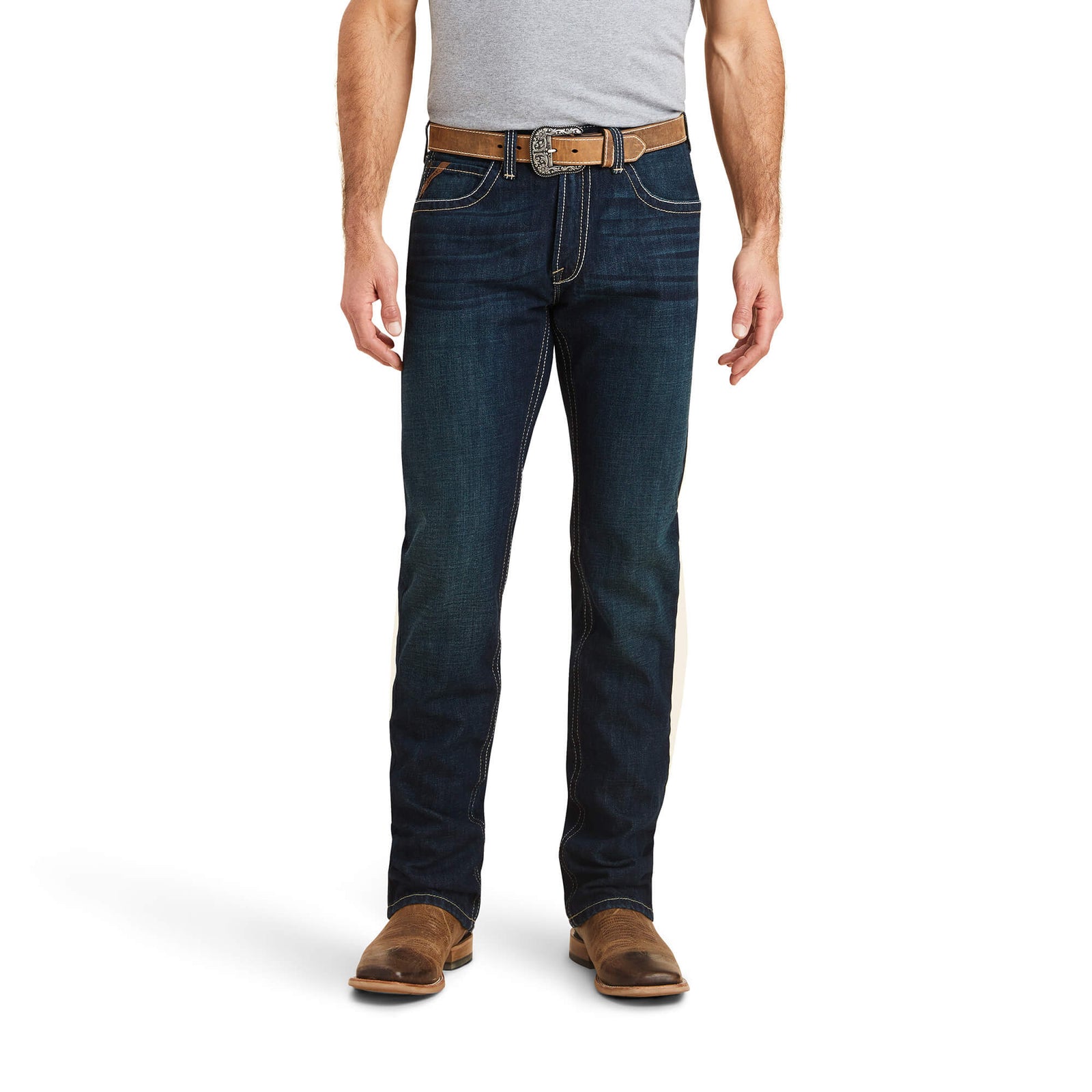 A man wearing Ariat Men's M5 Winifield Straight Leg Jeans with a belt and shoes, standing against a white background.