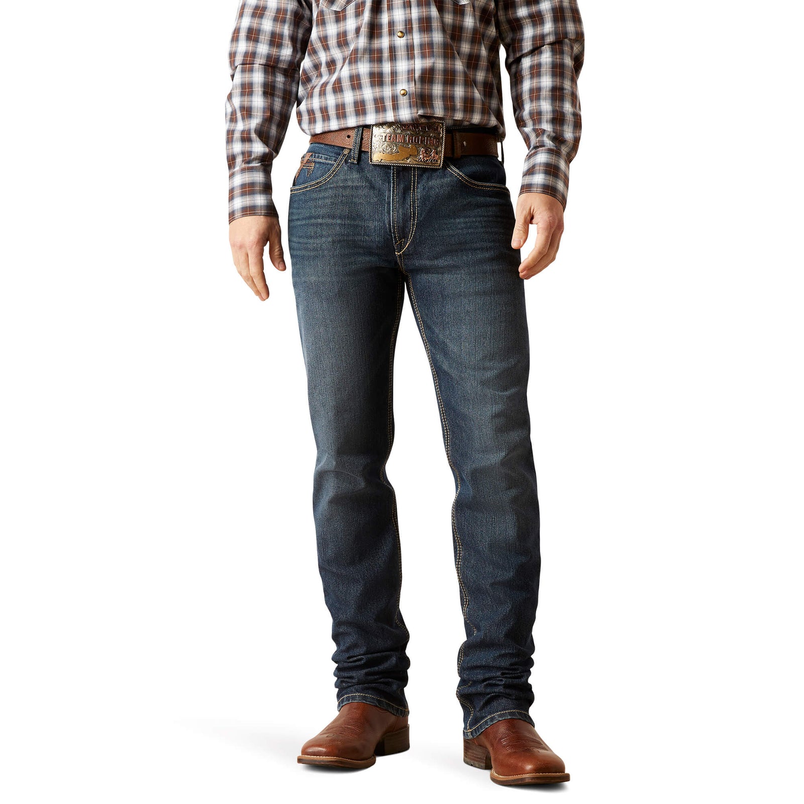 A man wearing Ariat Men's M4 Derek Relaxed Fit Boot Cut Jean, standing upright, full length view.
