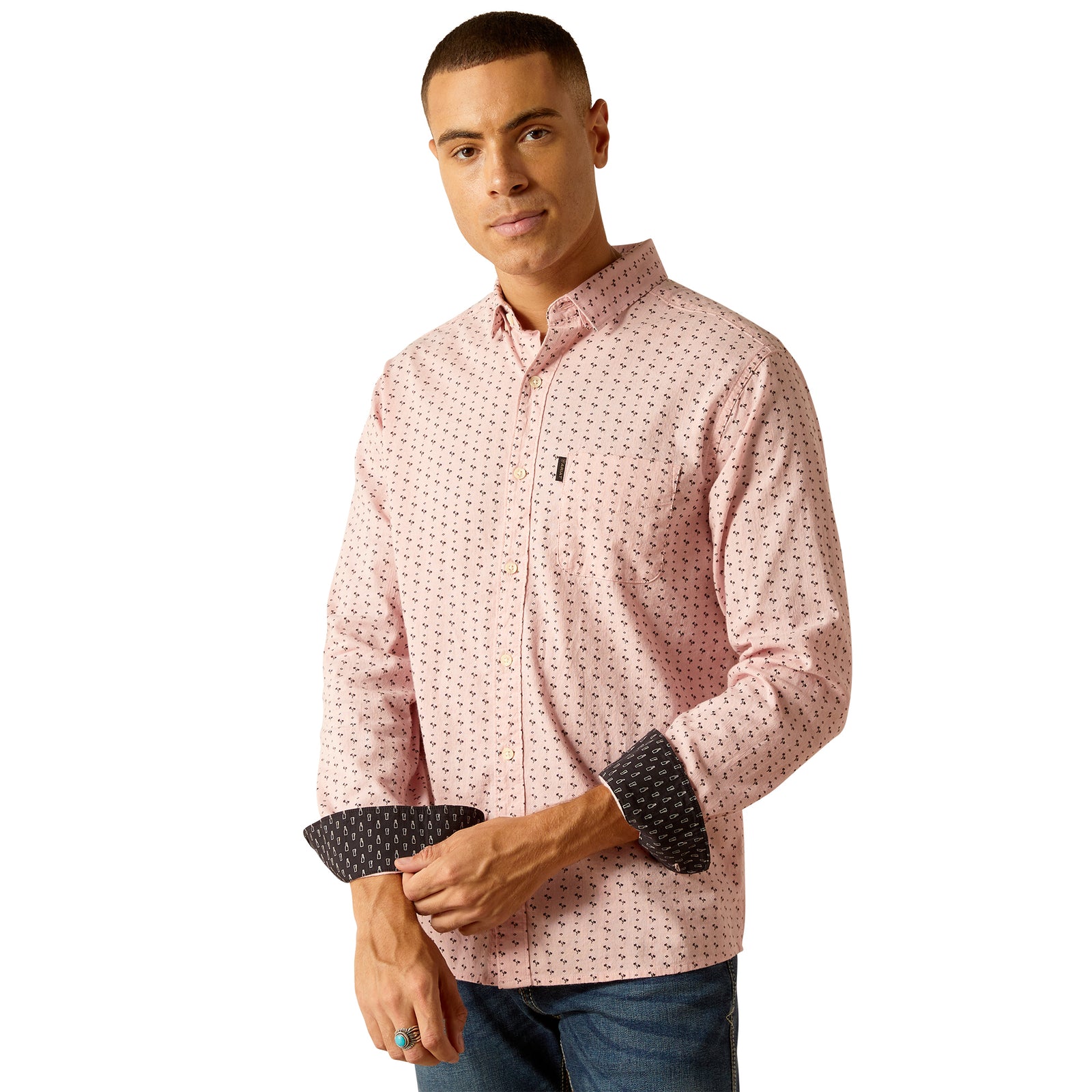 Ariat Men's Marshall Modern L/S Western Shirt. A man wearing a long-sleeved, pink, geometric patterned, western shirt with a hidden button-down collar and contrasting elbow patches.