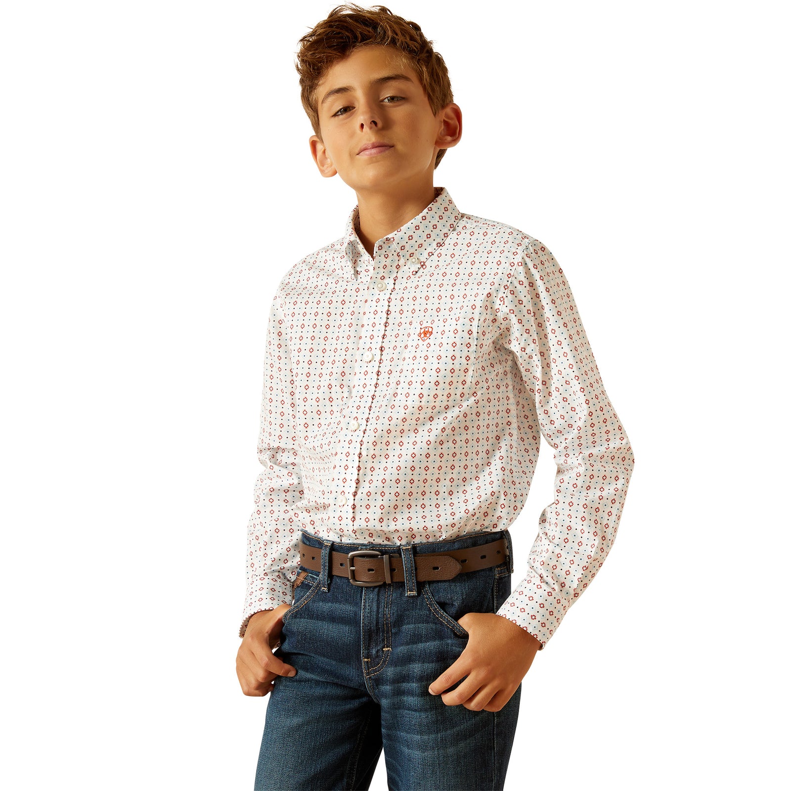 Ariat Boy's Kade L/S Western Shirt. A boy wearing a long-sleeved white checkered Western shirt with snap buttons and a front pocket, paired with blue jeans.