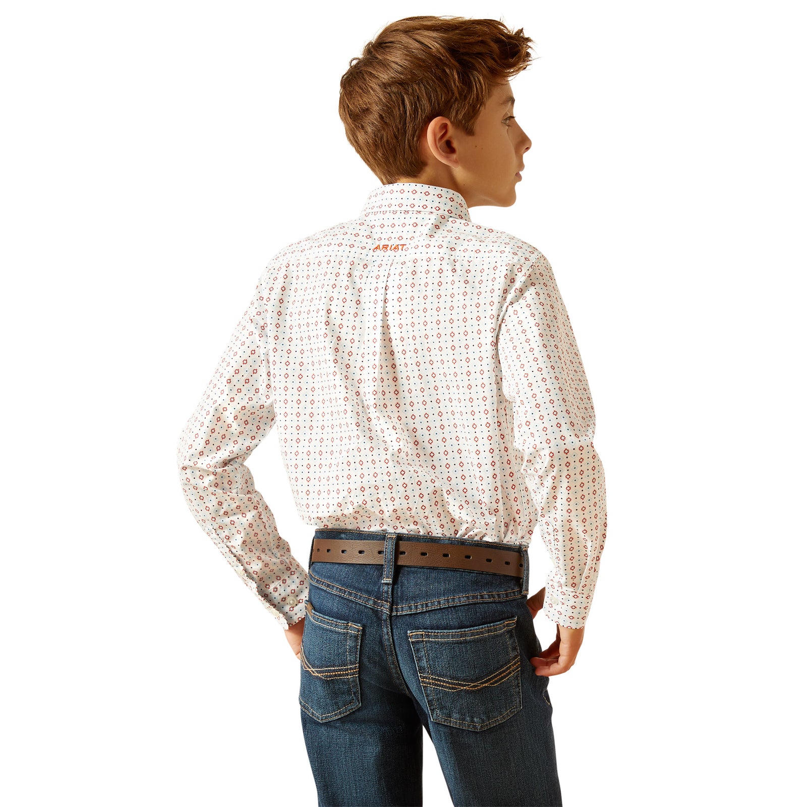 Ariat Boy's Kade L/S Western Shirt. A boy wearing a long-sleeved white checkered Western shirt with snap buttons and a front pocket, paired with blue jeans.