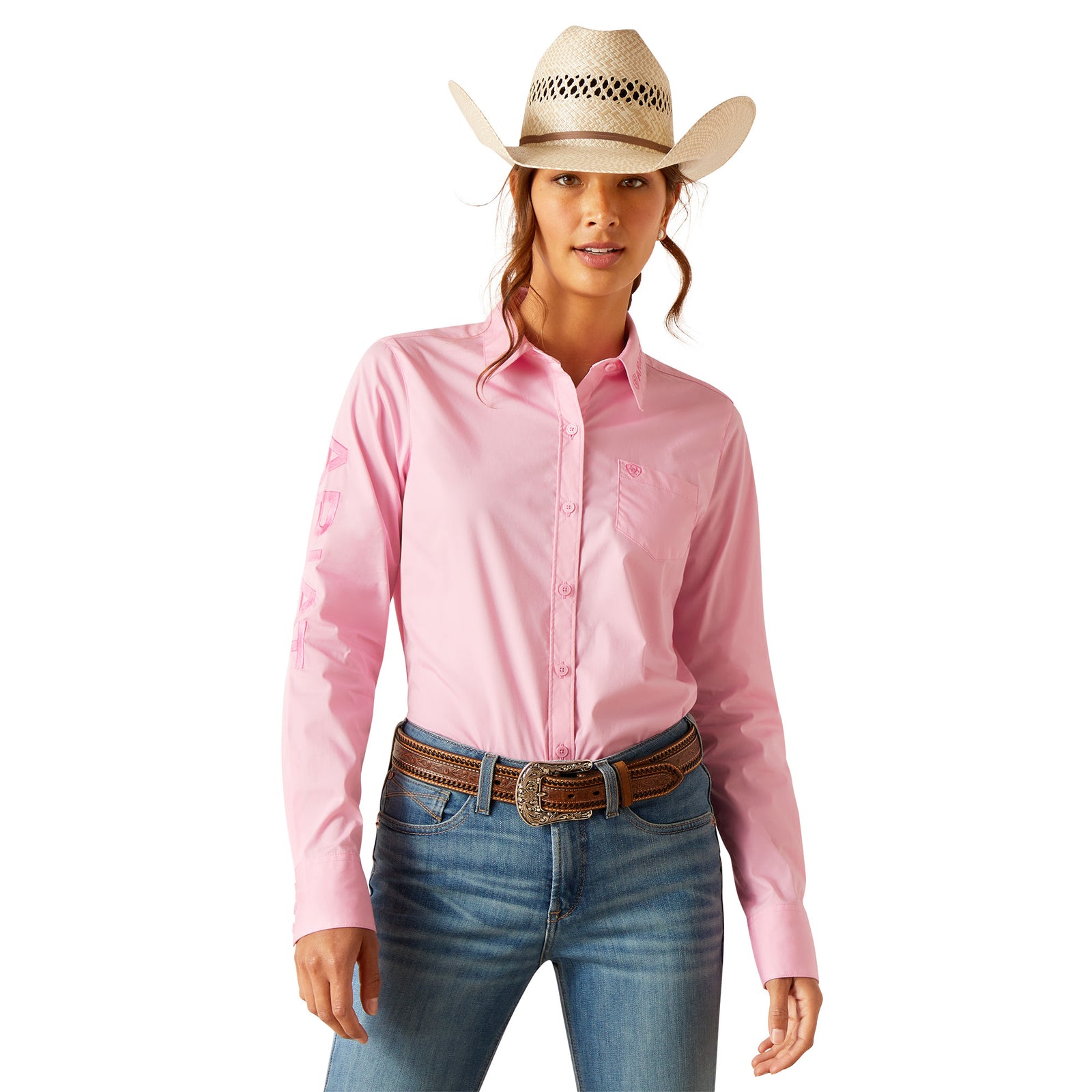Ariat Women's Kirby Stretch L/S Western Shirt. A woman wearing a pink long-sleeve western shirt with a white cowboy hat, blue jeans, and brown boots.