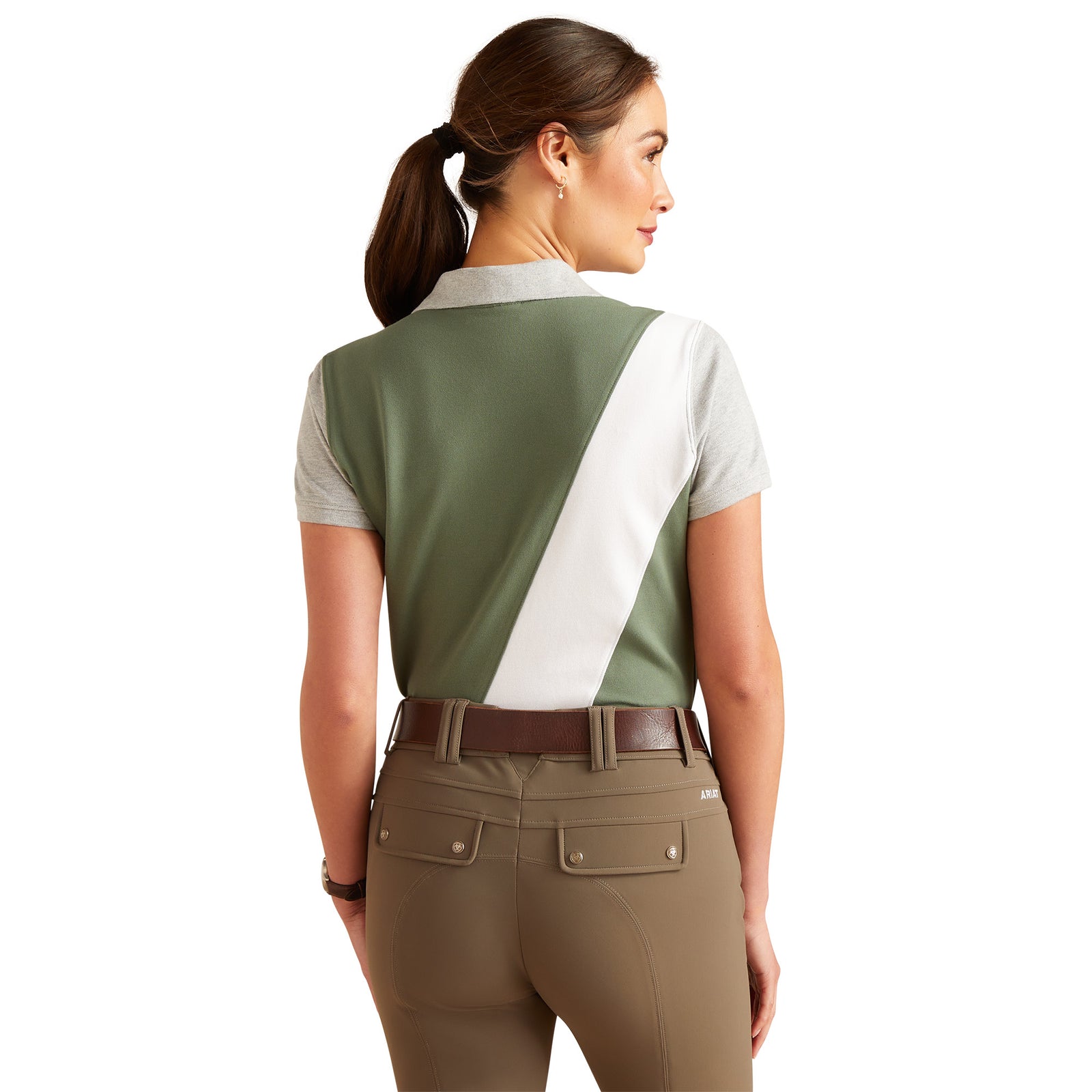 Ariat Women's Taryn S/S Polo. A woman wearing an Ariat brand polo shirt in green, white, and gray color blocking. The shirt features logo embroidery and contrast color blocking.