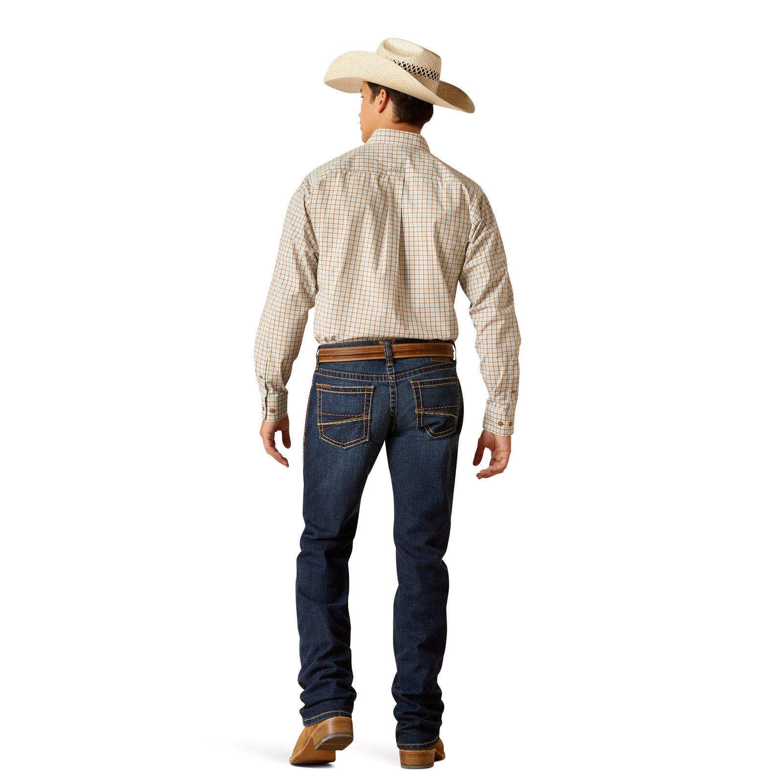 A man wearing Ariat M7 Gleeson Men's Slim Straight Leg Jean with a checkered shirt and a belt, standing against a white background.