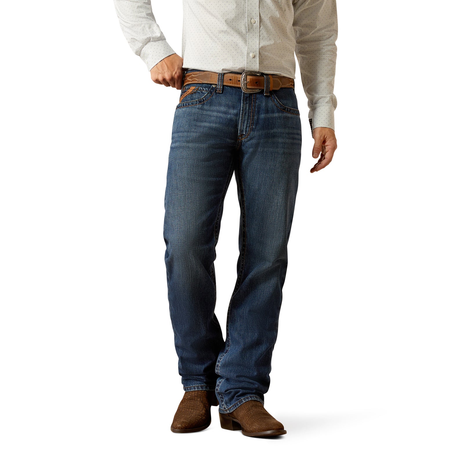 Ariat Men's M5 Romeo Straight Leg Jean. A man wearing a white shirt and blue straight leg jeans with a mid-rise waist and tan cowboy boots.