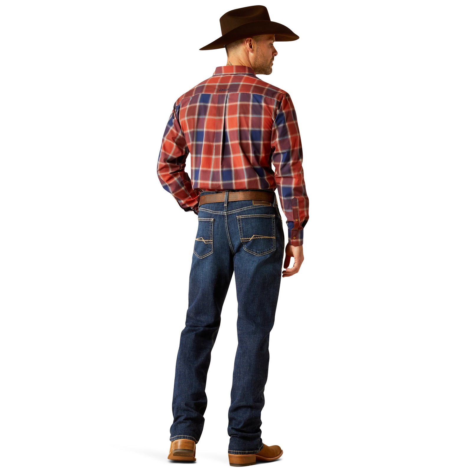 Ariat Men's M4 Challenger Relaxed Fit Jeans. A man standing straight, wearing a plaid shirt, a belt, and brown boots, with Ariat Men's M4 Challenger Relaxed Fit Jeans visible.