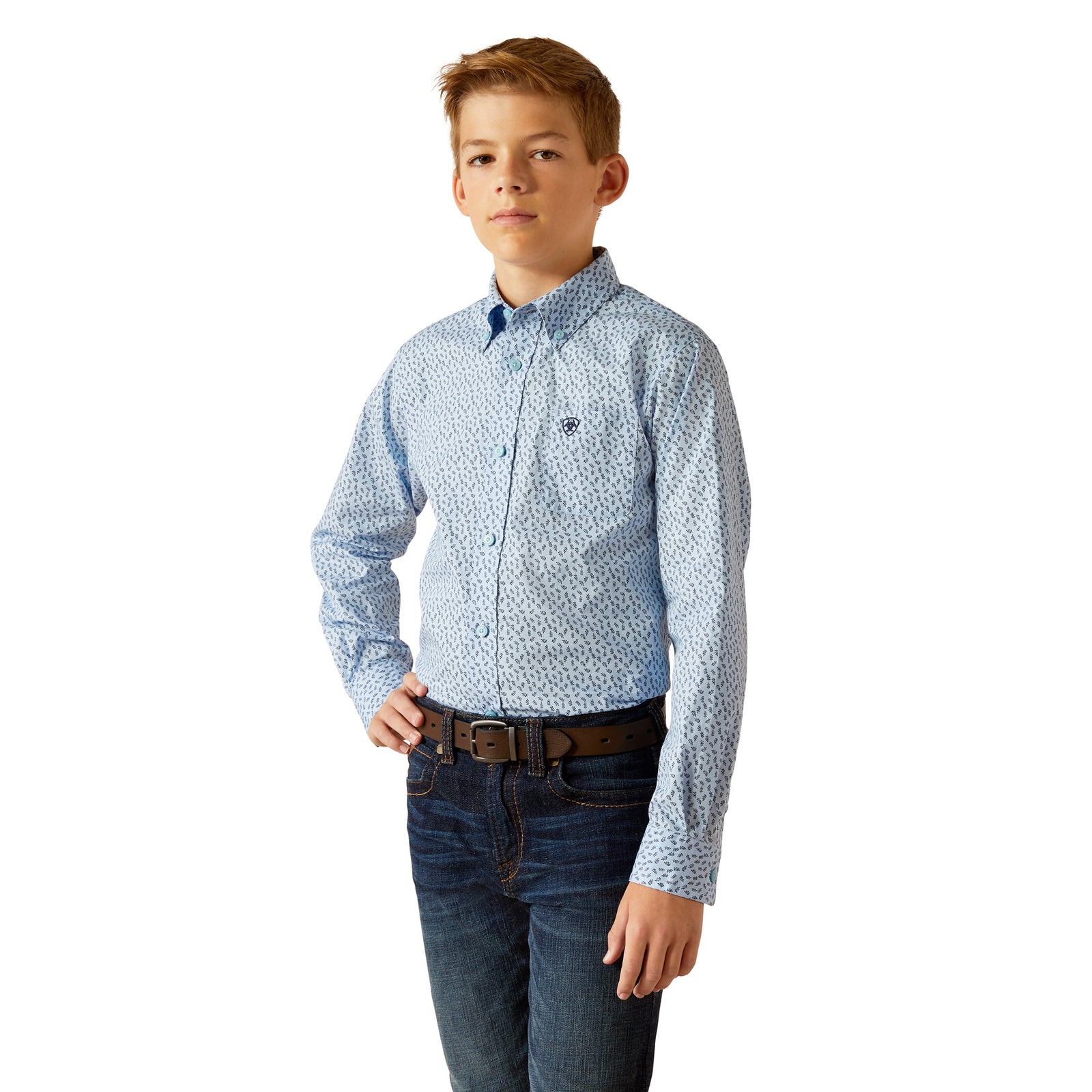 Ariat Boy's Rowan Classic Fit L/S Western Shirt. A boy wearing a long-sleeved blue and white geometric patterned Western shirt with a collar, button-up neck, and front button closure. He is also wearing blue jeans.