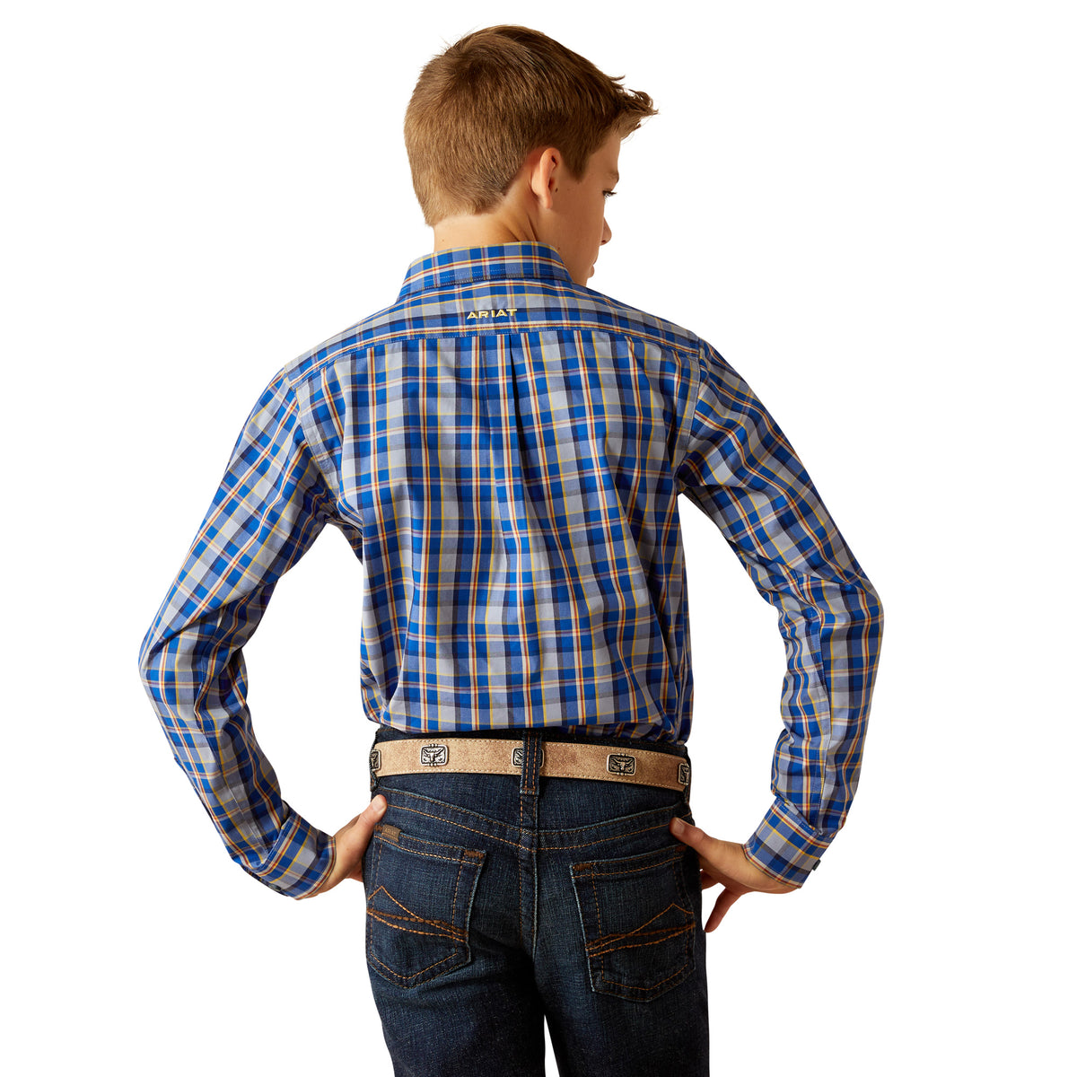 Ariat Boy's Reggie Pro L/S Western Shirt. A boy is shown from the back wearing a blue and white checkered long-sleeved western shirt with button-up collar, paired with blue jeans.