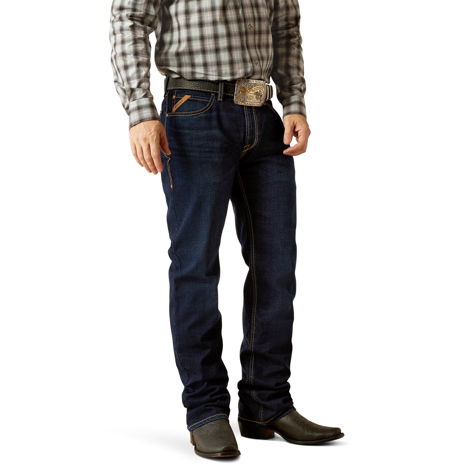 Ariat Mens M4 Relaxed Ranchford Boot Cut Jean. A man wearing a plaid shirt and Ariat men's relaxed ranchford boot cut jeans, standing against a white background.