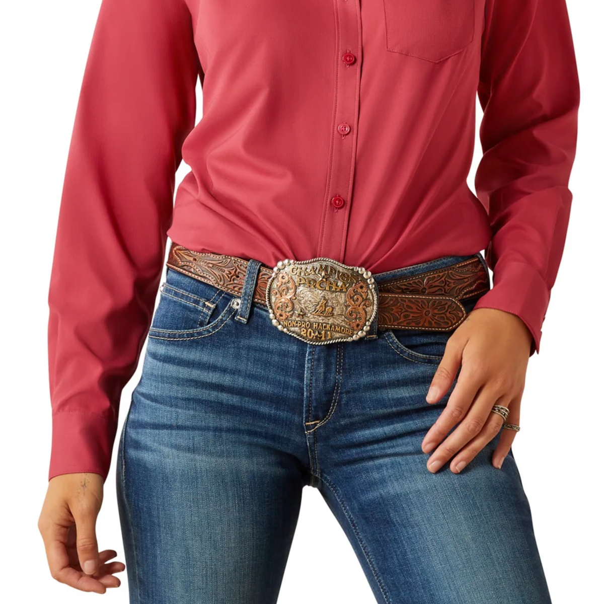 Person wearing a red shirt and blue jeans with a decorative belt buckle on a white background