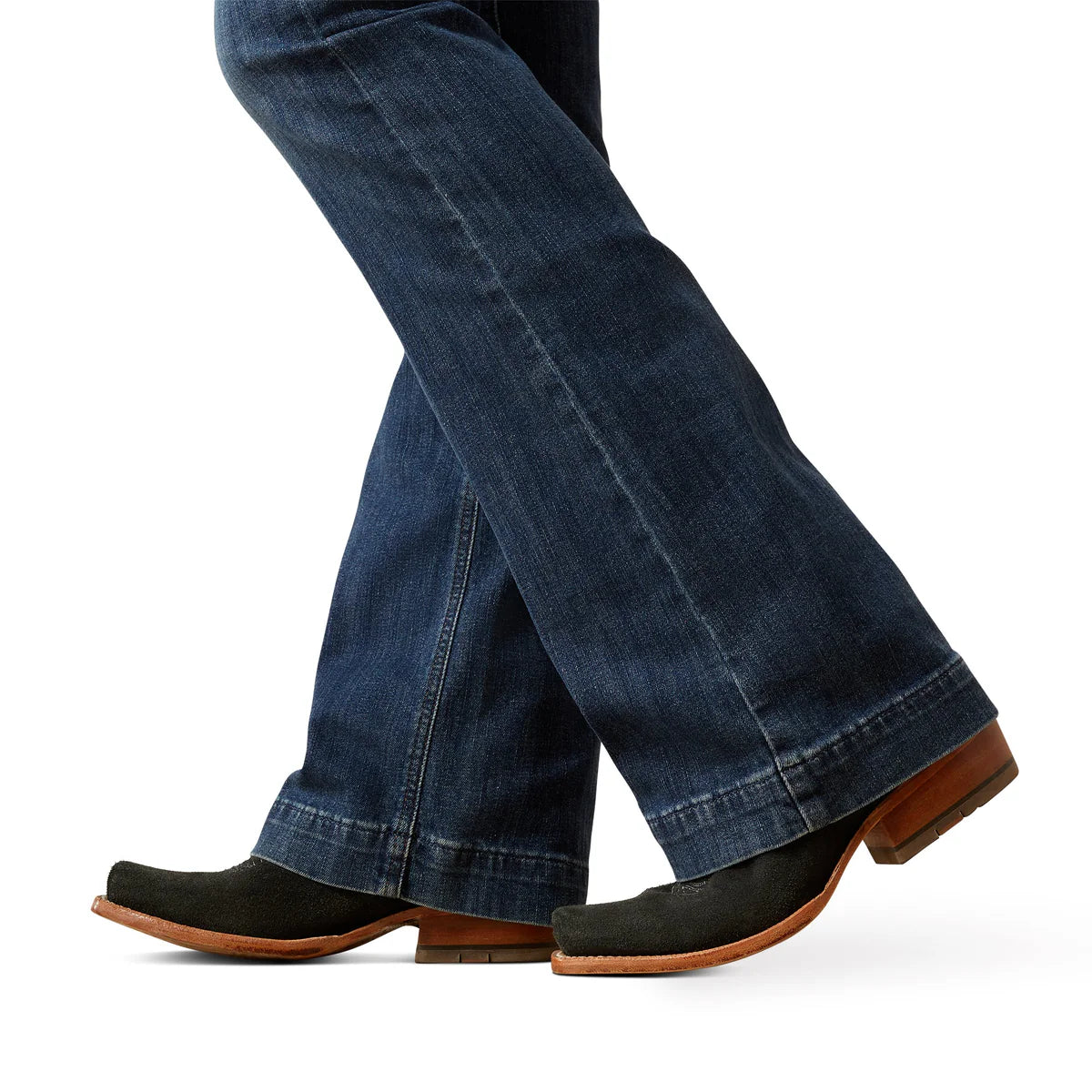 Close-up of blue jeans and black shoes on a white background