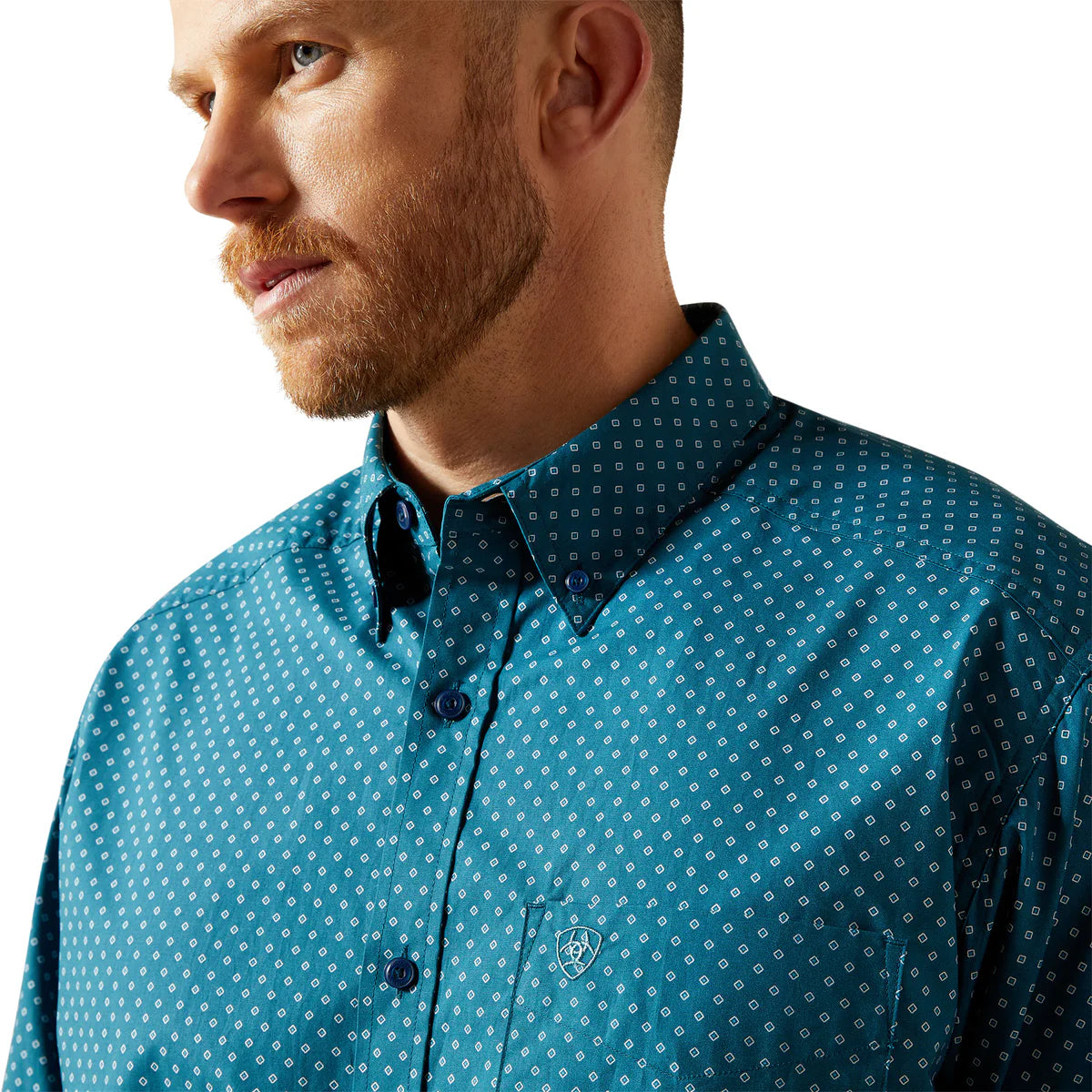 Man wearing a blue patterned shirt with a white background