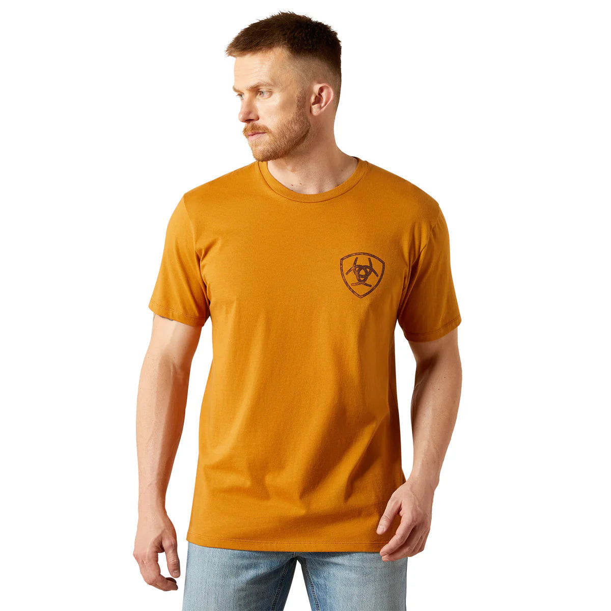 Man wearing a mustard yellow t-shirt with a logo on a white background