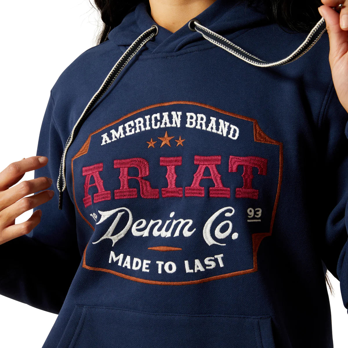 Navy hoodie with Ariat branding on a white background