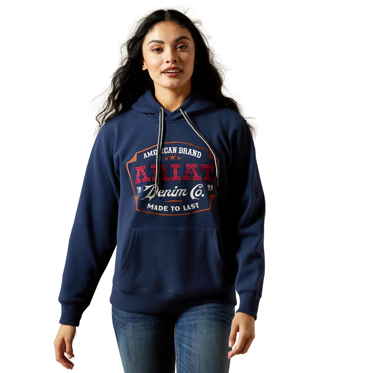Woman wearing a navy blue hoodie with branding on a white background