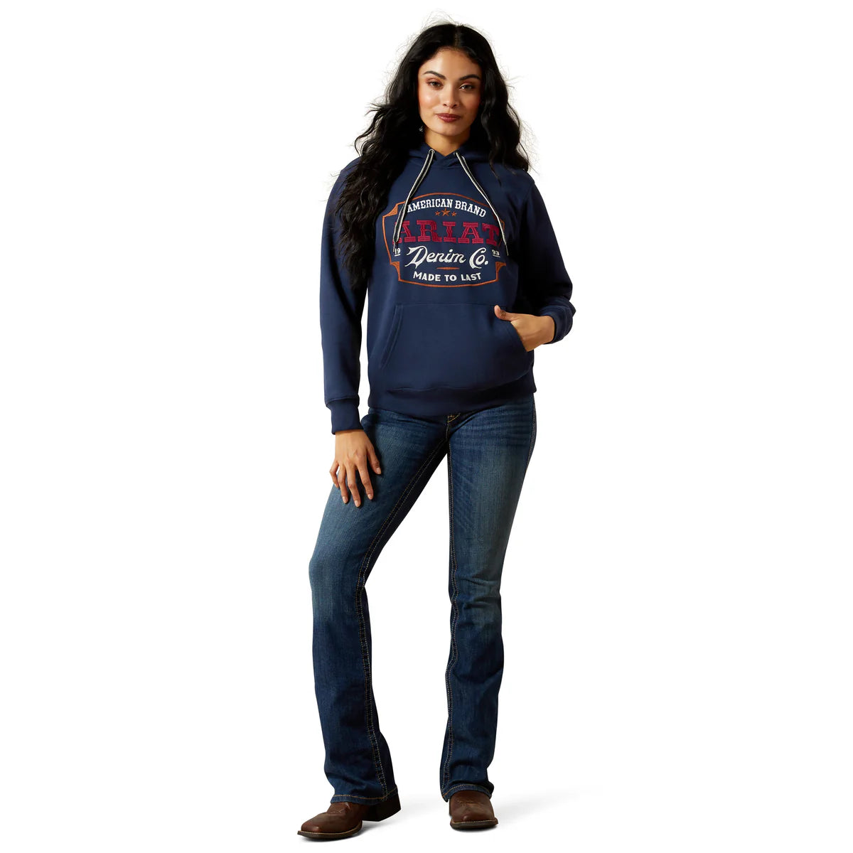Woman wearing a navy hoodie with text and jeans on a white background
