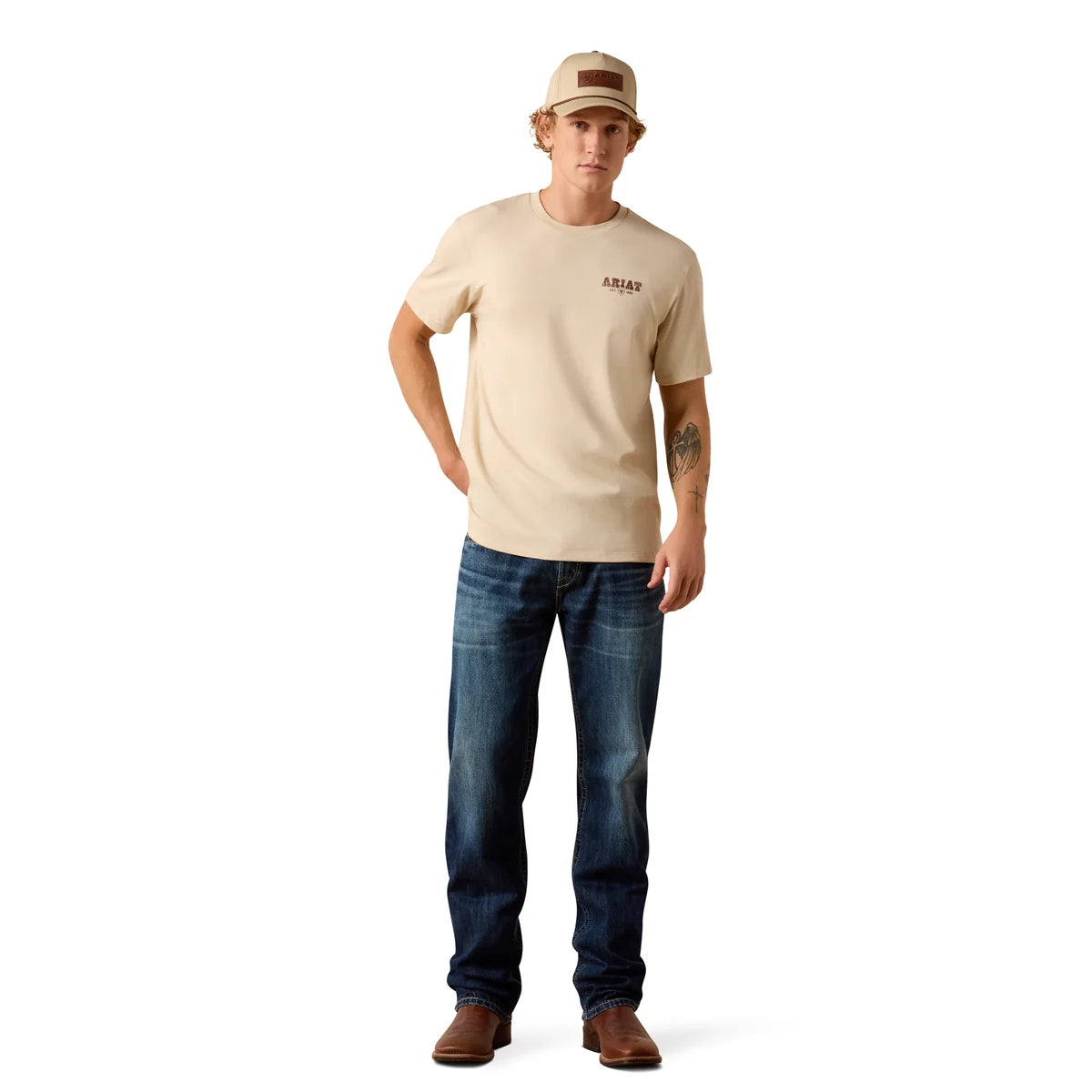 Man wearing a beige t-shirt and blue jeans on a white background