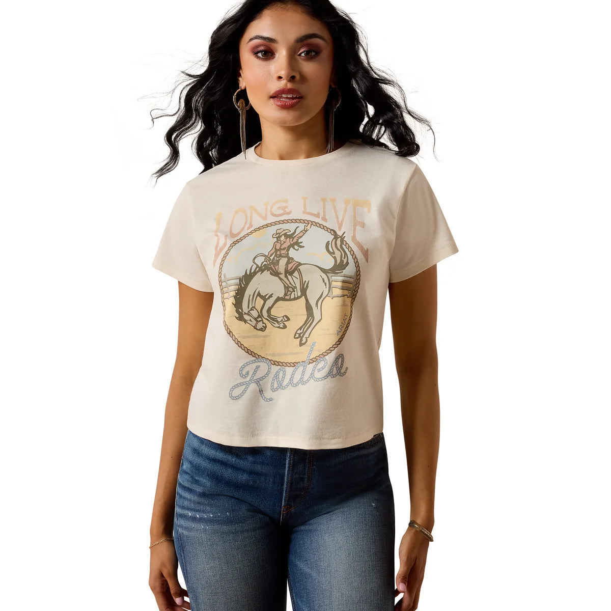 Woman wearing a beige t-shirt with a graphic design and text, standing against a white background