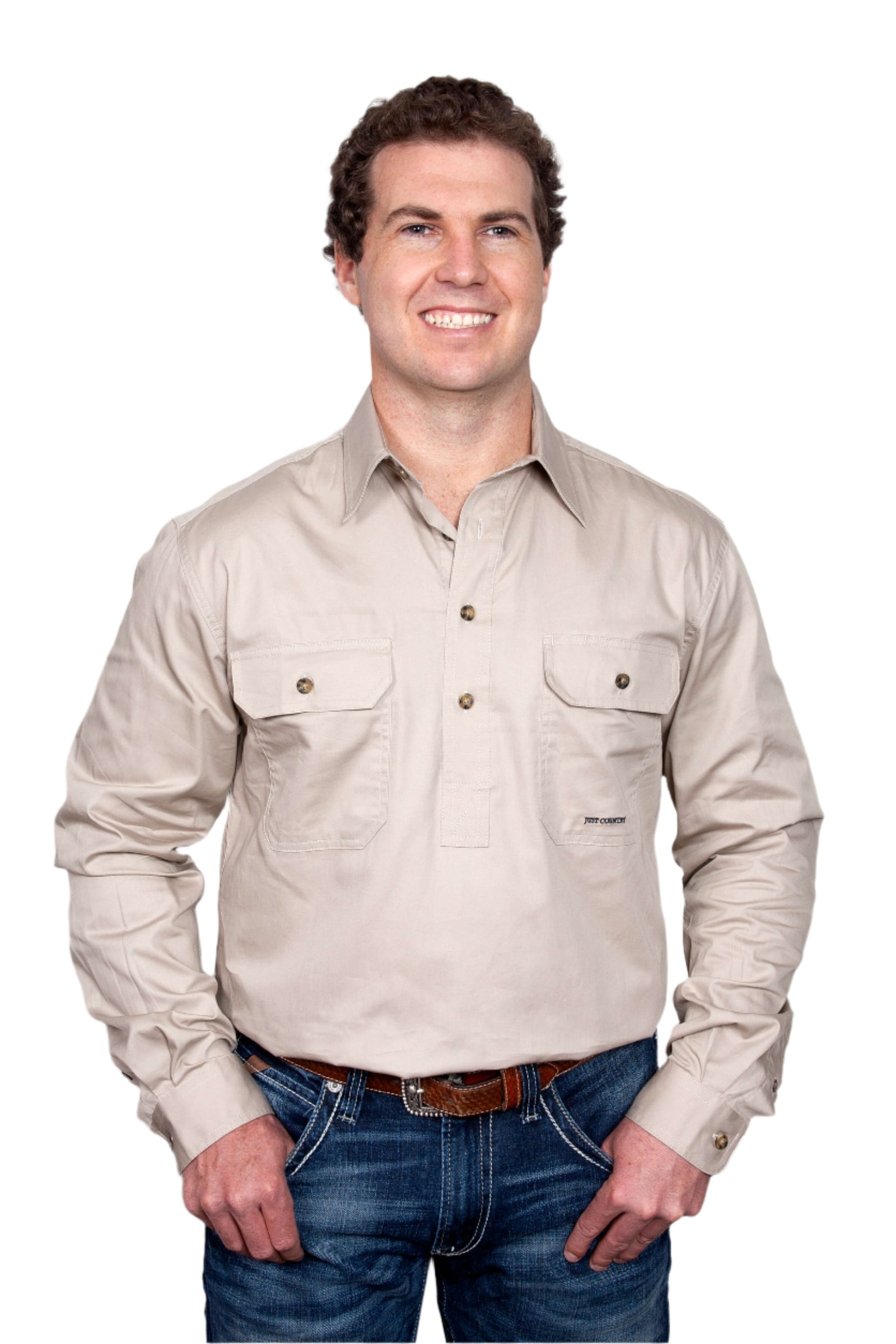 Just Country Men's Cameron L/S Workshirt. A man wearing a long-sleeved, collared, beige workshirt with double pockets.