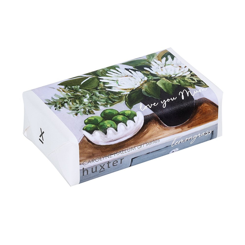Huxter lemon grass soap packaging with a wooden spoon and green leaves on a white background