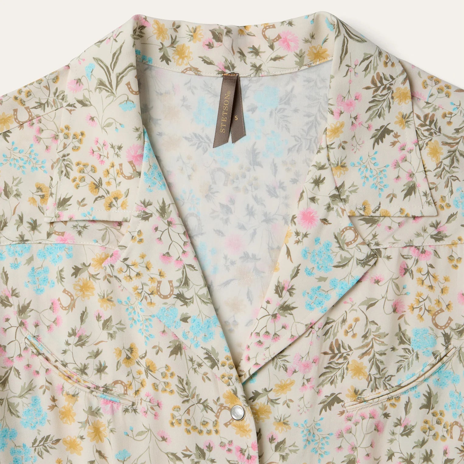 Floral patterned shirt with a visible brand tag on a white background