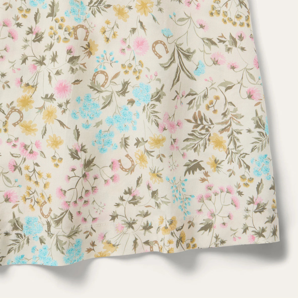 Floral patterned fabric with small flowers and leaves on a beige background