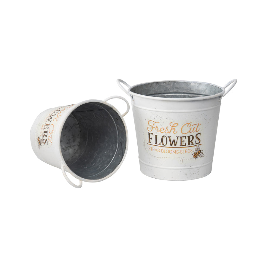 Fresh Cut Flowers Bucket Planters. Two metal buckets with floral designs on a white background