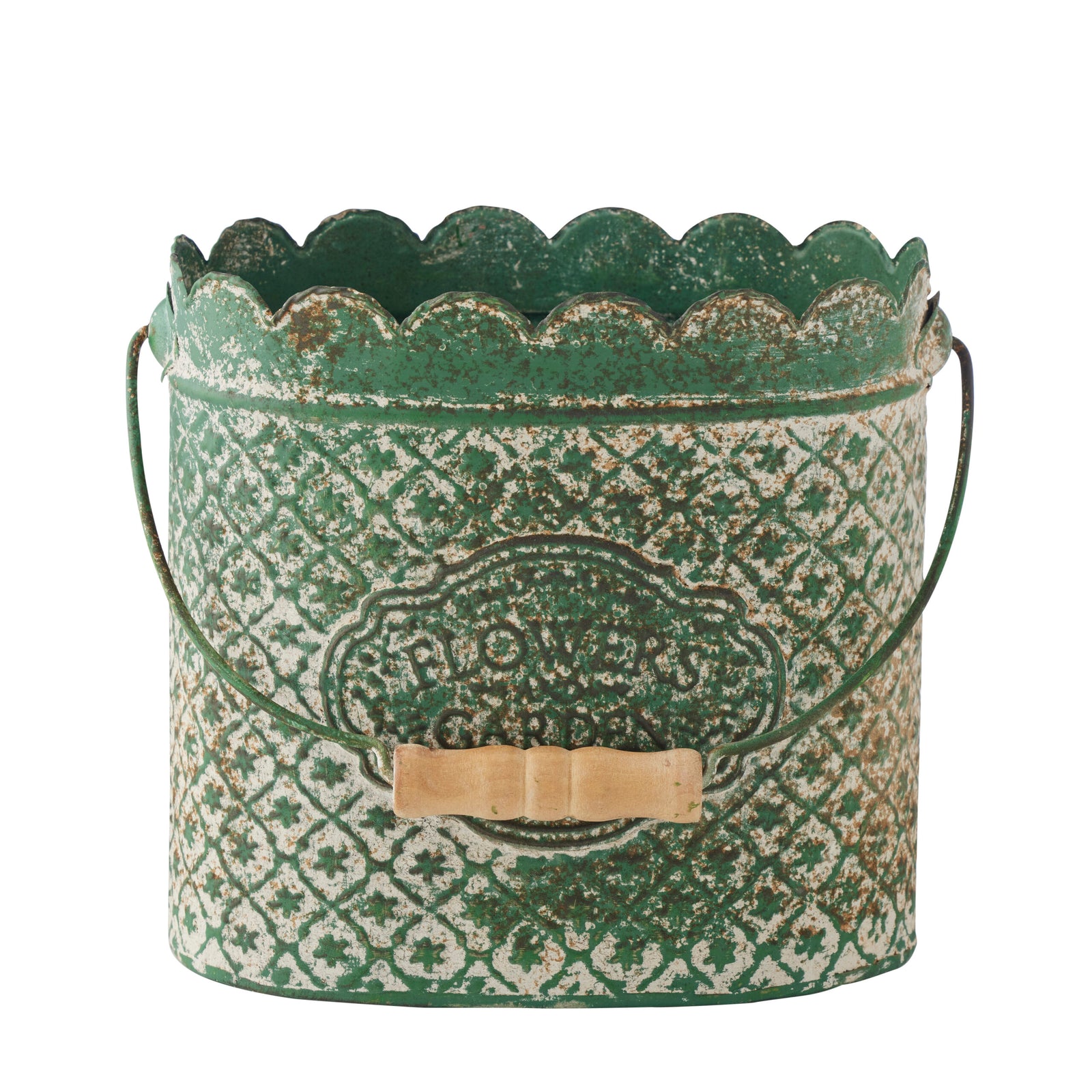 A distressed green metal bucket with a scalloped rim, embossed floral pattern, and a small wooden bow on the front, shown on a white background.