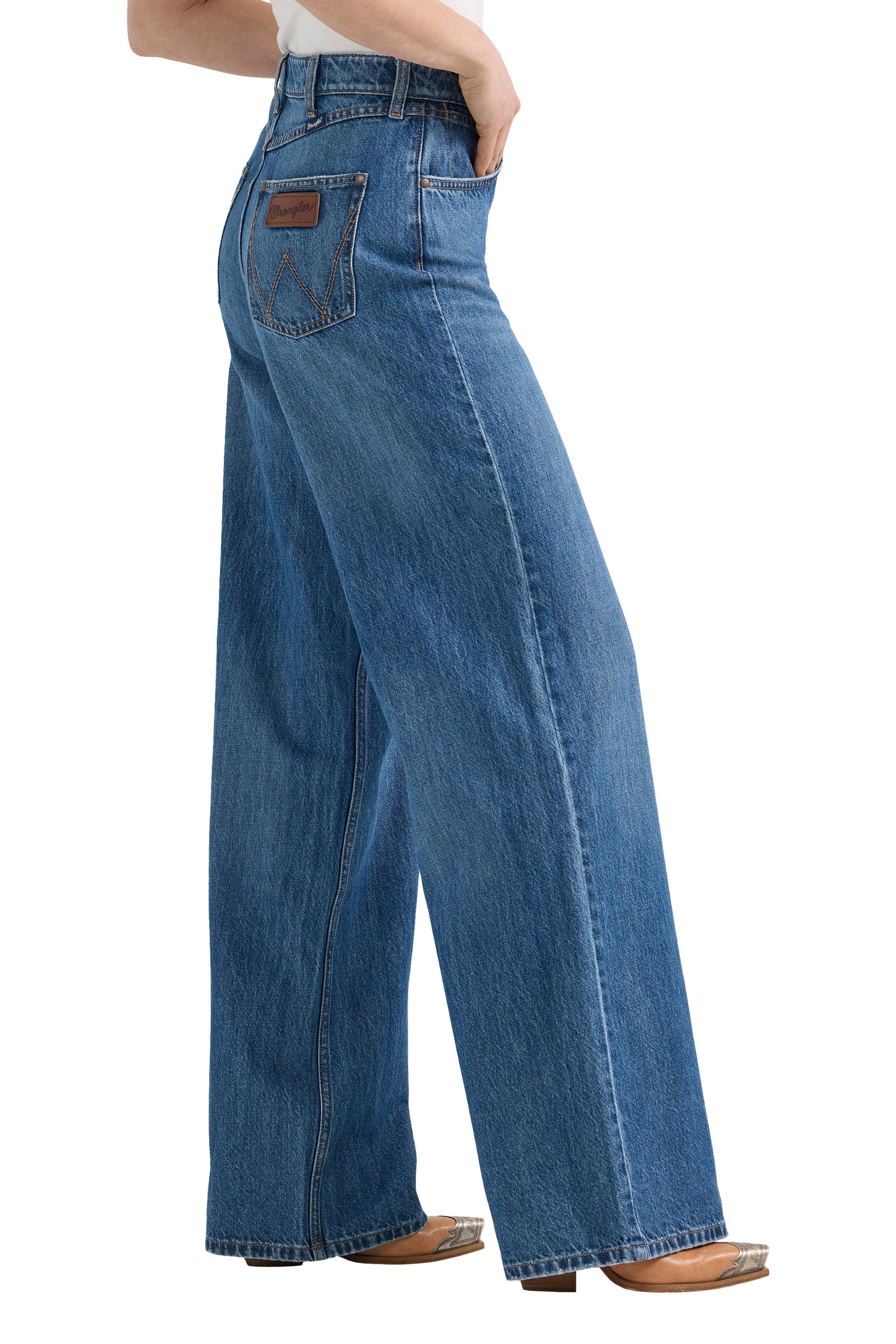 Blue jeans worn by a person on a white background